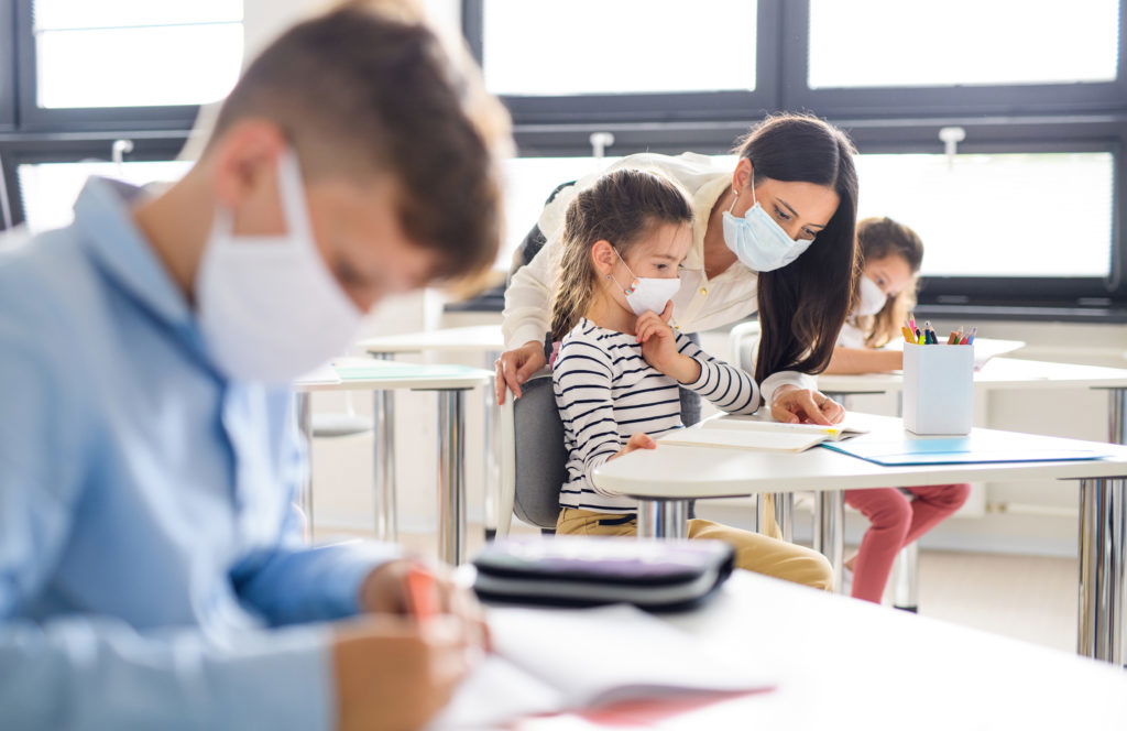Group of children with face mask back at school after covid-19 quarantine and lockdown. Group of children with face mask back at school after covid-19 quarantine and lockdown, learning.