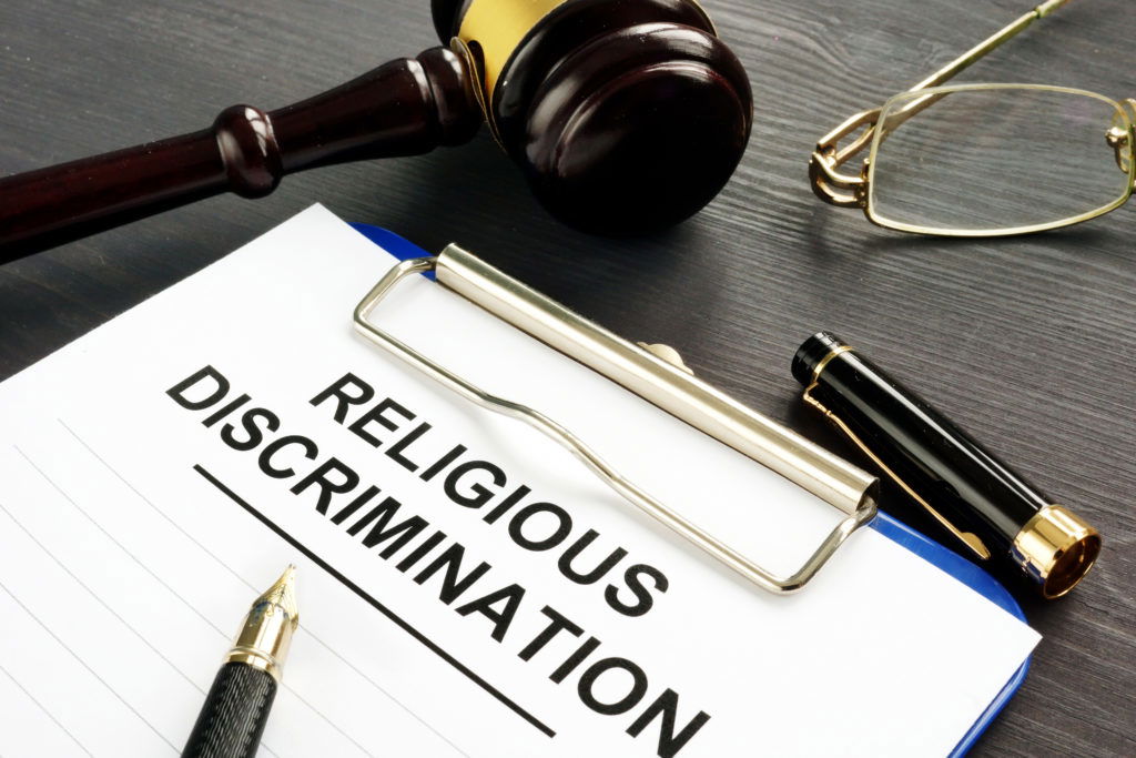 Religious Discrimination claim and pen on a table. Religious Discrimination claim and pen on a table.