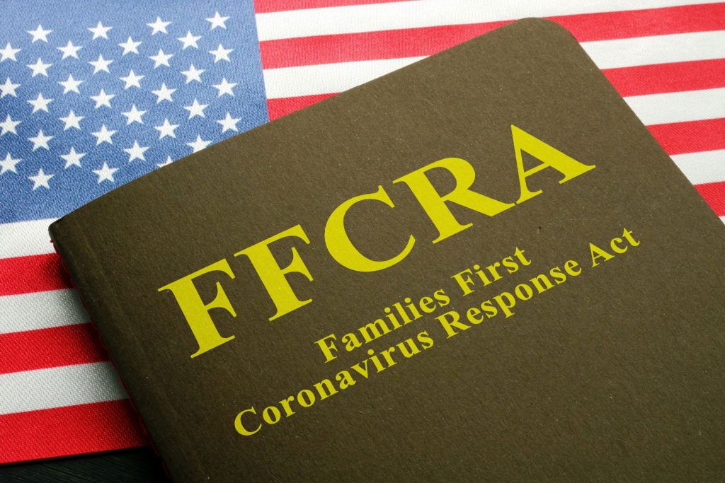 USA flag and families first coronavirus response act FFCRA law. USA flag and families first coronavirus response act FFCRA law.