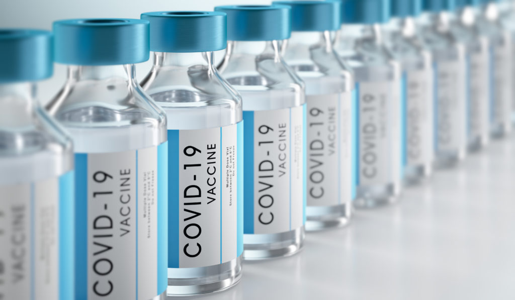 Row Covid-19 or Coronavirus vaccine flasks on white background