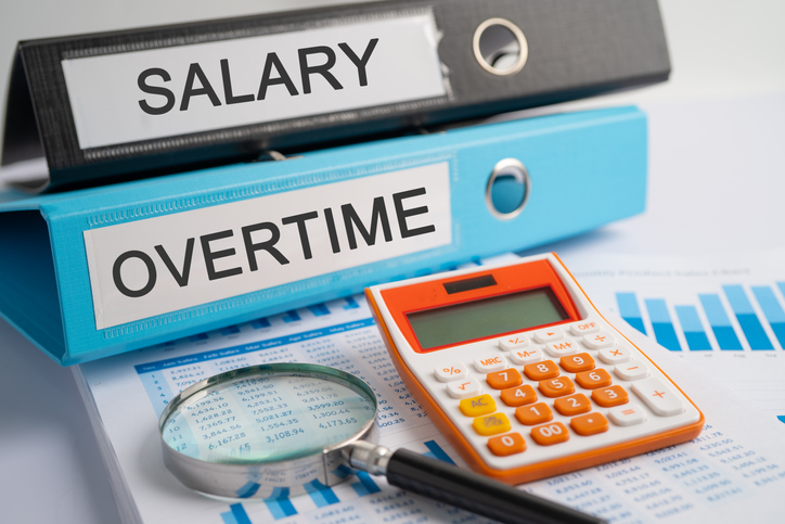 Salary, Overtime. Binder data finance report business with graph analysis in office.