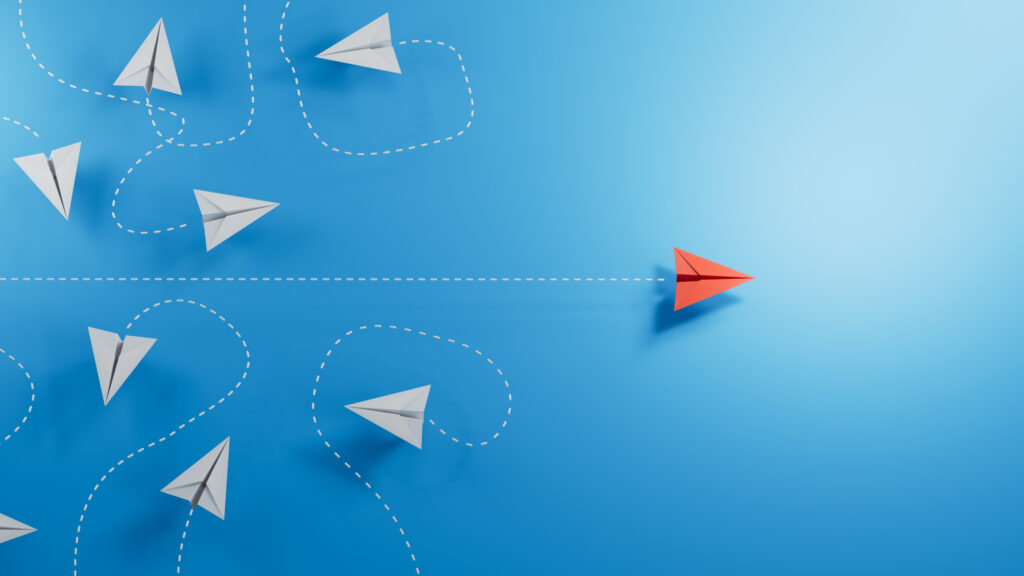 Red paper plane emerge from group of chaotic flying white paper planes on blue background, business concept for leaderplane, new ideas, innovation or creativity, 3D illustration